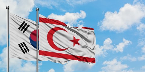 South Korea and Northern Cyprus flag waving in the wind against white cloudy blue sky together. Diplomacy concept, international relations.
