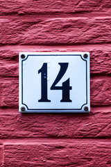 number 14 on brik wall
