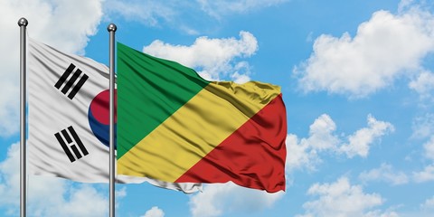 South Korea and Republic Of The Congo flag waving in the wind against white cloudy blue sky together. Diplomacy concept, international relations.