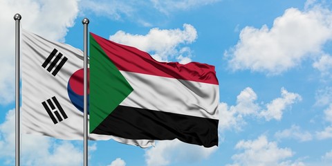 South Korea and Sudan flag waving in the wind against white cloudy blue sky together. Diplomacy concept, international relations.