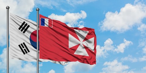 South Korea and Wallis And Futuna flag waving in the wind against white cloudy blue sky together. Diplomacy concept, international relations.