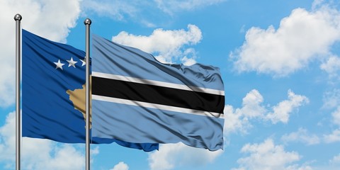 Kosovo and Botswana flag waving in the wind against white cloudy blue sky together. Diplomacy concept, international relations.