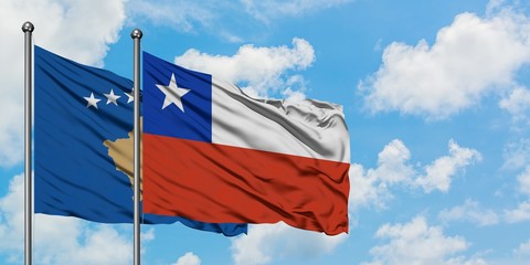 Kosovo and Chile flag waving in the wind against white cloudy blue sky together. Diplomacy concept, international relations.