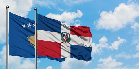 Kosovo and Dominican Republic flag waving in the wind against white cloudy blue sky together. Diplomacy concept, international relations.