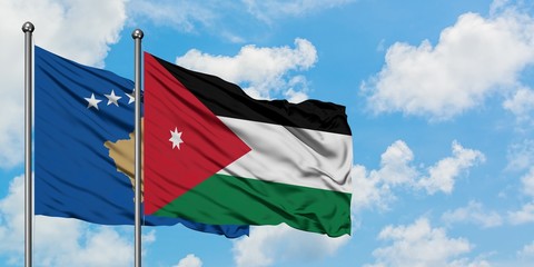 Kosovo and Jordan flag waving in the wind against white cloudy blue sky together. Diplomacy concept, international relations.