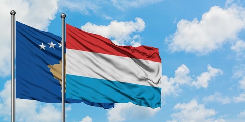 Kosovo and Luxembourg flag waving in the wind against white cloudy blue sky together. Diplomacy concept, international relations.