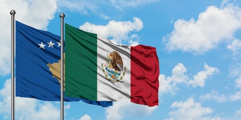 Kosovo and Mexico flag waving in the wind against white cloudy blue sky together. Diplomacy concept, international relations.