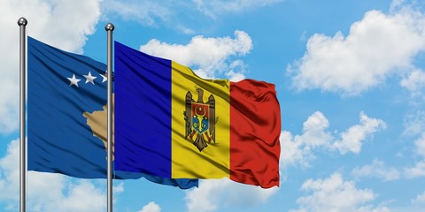 Kosovo and Moldova flag waving in the wind against white cloudy blue sky together. Diplomacy concept, international relations.