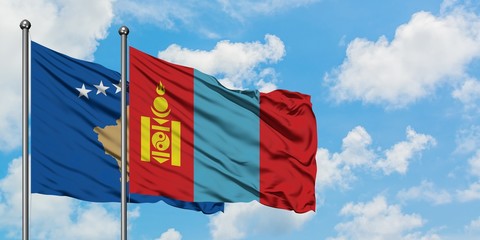 Kosovo and Mongolia flag waving in the wind against white cloudy blue sky together. Diplomacy concept, international relations.
