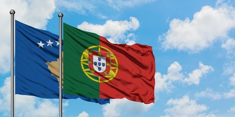 Kosovo and Portugal flag waving in the wind against white cloudy blue sky together. Diplomacy concept, international relations.