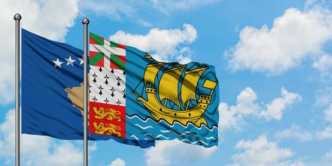 Kosovo and Saint Pierre And Miquelon flag waving in the wind against white cloudy blue sky together. Diplomacy concept, international relations.
