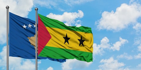 Kosovo and Sao Tome And Principe flag waving in the wind against white cloudy blue sky together. Diplomacy concept, international relations.
