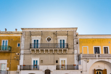 houses with shutters and balcony in historical town Monte Sant Angelo, Italy