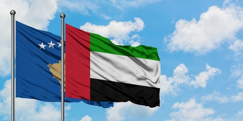 Kosovo and United Arab Emirates flag waving in the wind against white cloudy blue sky together. Diplomacy concept, international relations.