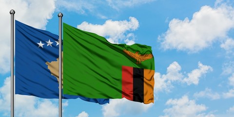 Kosovo and Zambia flag waving in the wind against white cloudy blue sky together. Diplomacy concept, international relations.