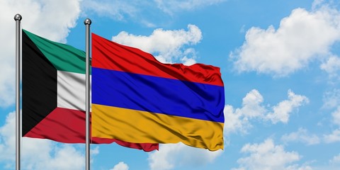 Kuwait and Armenia flag waving in the wind against white cloudy blue sky together. Diplomacy concept, international relations.