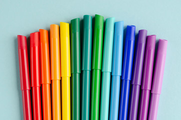Colored felt tip pens composition on blue background.