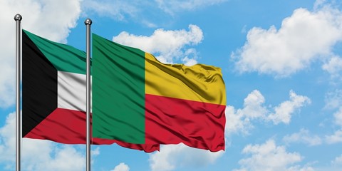 Kuwait and Benin flag waving in the wind against white cloudy blue sky together. Diplomacy concept, international relations.