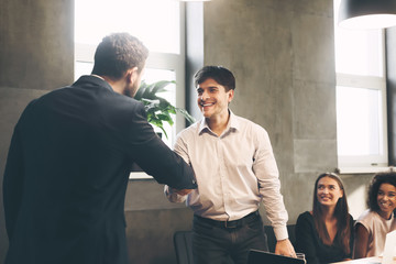 Boss promoting worker showing respect and shaking hands