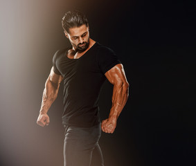 Handsome Male Fitness Model Wearing Jeans and Black T-Shirts