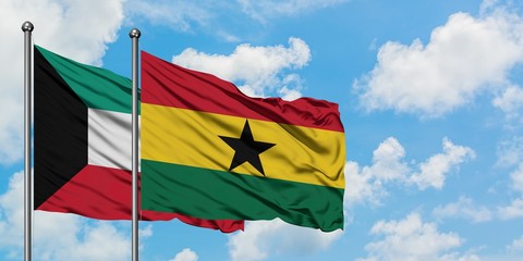 Kuwait and Ghana flag waving in the wind against white cloudy blue sky together. Diplomacy concept, international relations.