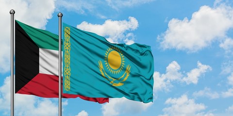 Kuwait and Kazakhstan flag waving in the wind against white cloudy blue sky together. Diplomacy concept, international relations.