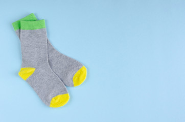 Kids socks composition on blue background. Flat lay.