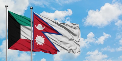 Kuwait and Nepal flag waving in the wind against white cloudy blue sky together. Diplomacy concept, international relations.