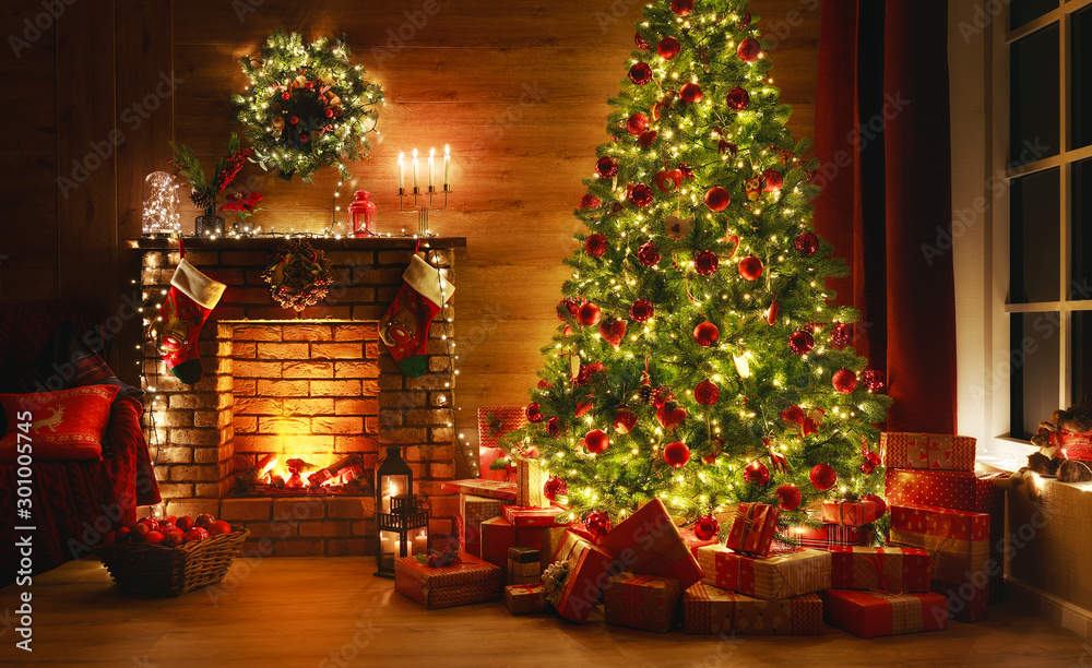 Wall mural interior christmas. magic glowing tree, fireplace, gifts in dark