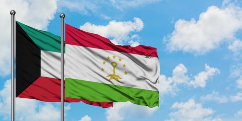 Kuwait and Tajikistan flag waving in the wind against white cloudy blue sky together. Diplomacy concept, international relations.