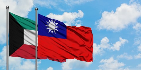 Kuwait and Taiwan flag waving in the wind against white cloudy blue sky together. Diplomacy concept, international relations.