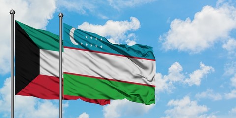 Kuwait and Uzbekistan flag waving in the wind against white cloudy blue sky together. Diplomacy concept, international relations.