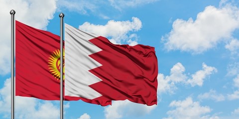 Kyrgyzstan and Bahrain flag waving in the wind against white cloudy blue sky together. Diplomacy concept, international relations.