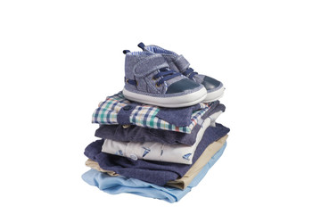 Toddler shoes and pile of clothes isolated on white background with clipping path, Baby clothes