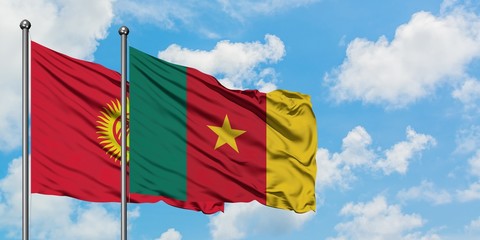 Kyrgyzstan and Cameroon flag waving in the wind against white cloudy blue sky together. Diplomacy concept, international relations.