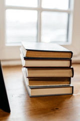 a stack of old books on the windowsill