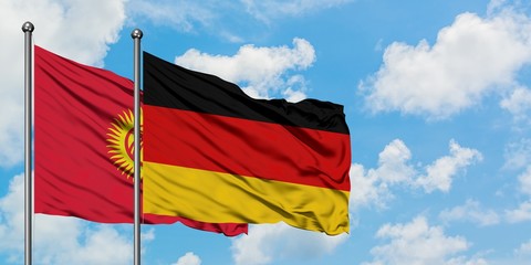 Kyrgyzstan and Germany flag waving in the wind against white cloudy blue sky together. Diplomacy concept, international relations.
