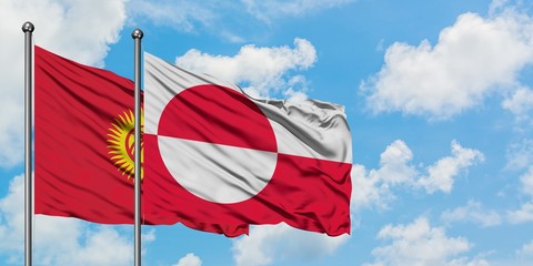 Kyrgyzstan and Greenland flag waving in the wind against white cloudy blue sky together. Diplomacy concept, international relations.