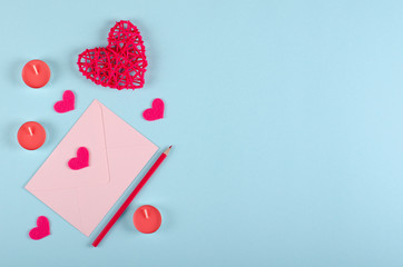 Red heart composition on blue background. Flat lay.