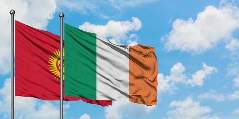 Kyrgyzstan and Ireland flag waving in the wind against white cloudy blue sky together. Diplomacy concept, international relations.