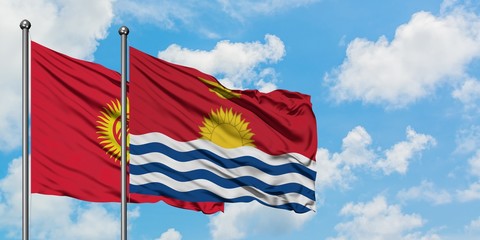 Kyrgyzstan and Kiribati flag waving in the wind against white cloudy blue sky together. Diplomacy concept, international relations.