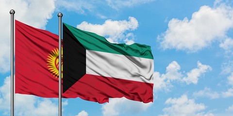 Kyrgyzstan and Kuwait flag waving in the wind against white cloudy blue sky together. Diplomacy concept, international relations.