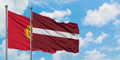 Kyrgyzstan and Latvia flag waving in the wind against white cloudy blue sky together. Diplomacy concept, international relations.