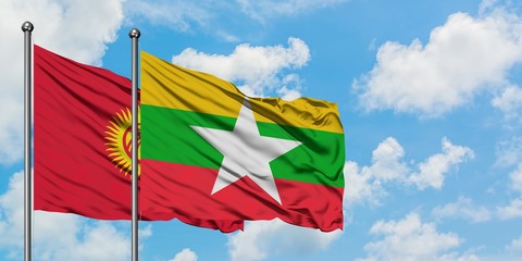 Kyrgyzstan and Myanmar flag waving in the wind against white cloudy blue sky together. Diplomacy concept, international relations.