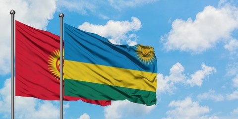 Kyrgyzstan and Rwanda flag waving in the wind against white cloudy blue sky together. Diplomacy concept, international relations.