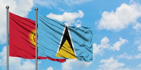 Kyrgyzstan and Saint Lucia flag waving in the wind against white cloudy blue sky together. Diplomacy concept, international relations.