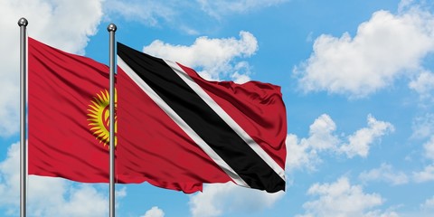 Kyrgyzstan and Trinidad And Tobago flag waving in the wind against white cloudy blue sky together. Diplomacy concept, international relations.