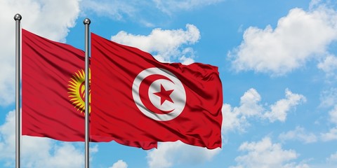 Kyrgyzstan and Tunisia flag waving in the wind against white cloudy blue sky together. Diplomacy concept, international relations.