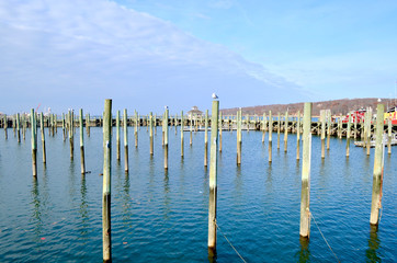 All the docks have been removed and stored for winter leaving only the pillings standing guard. Town Marina at Port Jefferson Harbor, Long Island