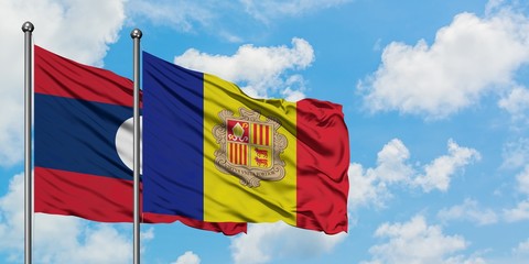 Laos and Andorra flag waving in the wind against white cloudy blue sky together. Diplomacy concept, international relations.